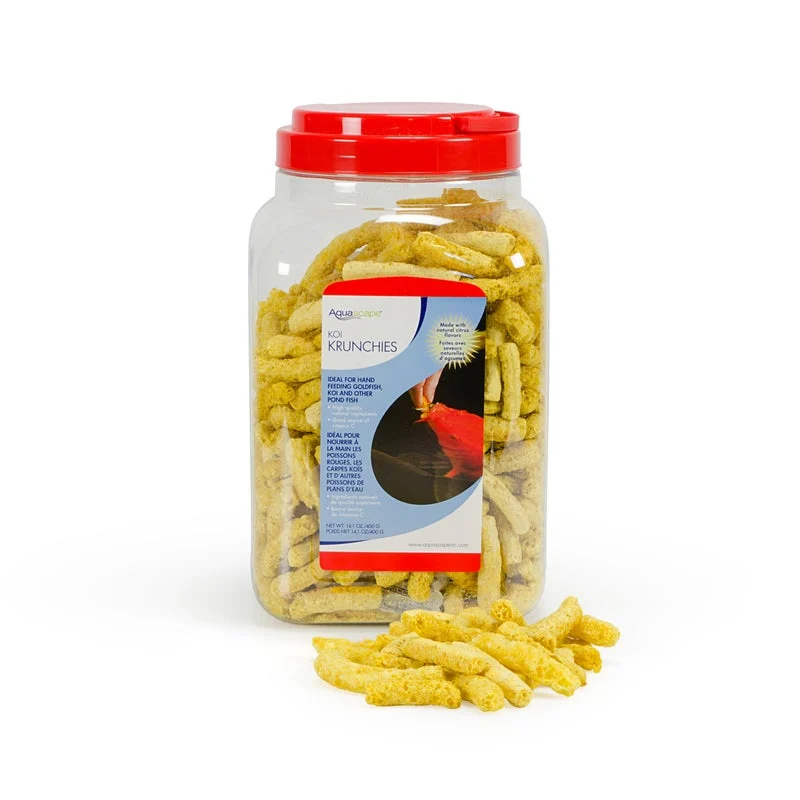 Clear plastic container with red lid filled with yellow corn-based fish food pellets, some scattered in front