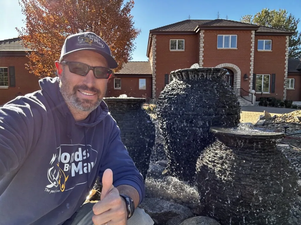 Justin of Ponds By May giving a thumbs-up beside three finished urn fountains